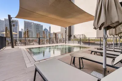 a swimming pool on the roof of a building at Waves - Stylish Studio Near Downtown Dubai in Dubai