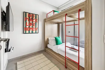 a bedroom with a bunk bed with red rails at New 2.5 BR Villa With PS5 and Garden Near Dubai Mall in Dubai