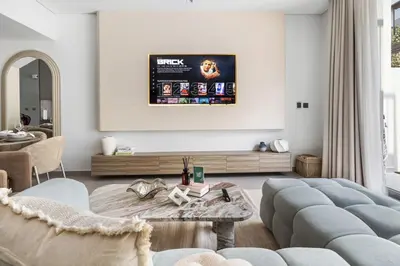 a living room with a couch and a table at New 2.5 BR Villa With PS5 and Garden Near Dubai Mall in Dubai