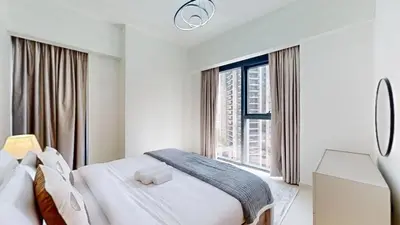 a bedroom with two beds and a large window at Vacationer l Vibrant 2 Bedroom l Pool with Burj Khalifa View in Dubai