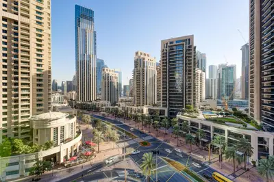a city with tall buildings and a street with cars at Vacationer l Vibrant 2 Bedroom l Pool with Burj Khalifa View in Dubai