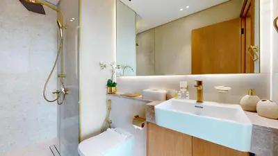 a bathroom with a sink and a toilet and a mirror at Binghatti Tulip - High Rise Upgraded Studio in JVC in Dubai