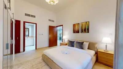 a bedroom with a bed and a glass door at Sherlock House 2 - Peaceful One Bed in Motor City in Dubai