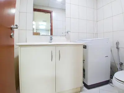 a bathroom with a sink and a mirror and a toilet at Sherlock House 2 - Peaceful One Bed in Motor City in Dubai