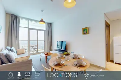 a living room with a couch and a table at Studio One - Sleek One Bedroom with City View in Dubai