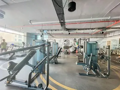a gym with several treadmills and machines at Studio One - Sleek One Bedroom with City View in Dubai