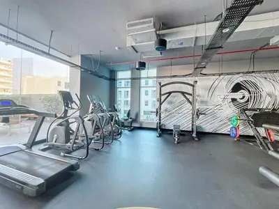 a fitness room with cardio equipment in a building at Studio One - Sleek One Bedroom with City View in Dubai