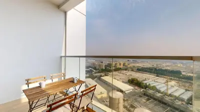 an empty room with a bench and a large window at Studio One - Sleek One Bedroom with City View in Dubai