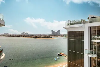 a view of a body of water next to a building at Palm Jumeirah Luxury Apt Direct Beach Access & Views in Dubai
