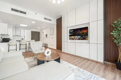 a living room with a couch and a table at Palm Jumeirah Luxury Apt Direct Beach Access & Views in Dubai