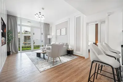 a living room with white chairs and a couch at Palm Jumeirah Luxury Apt Direct Beach Access & Views in Dubai