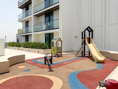 a playground in front of a building with a slide at GuestReady - Top-Floor Tranquillity in JVC in Dubai
