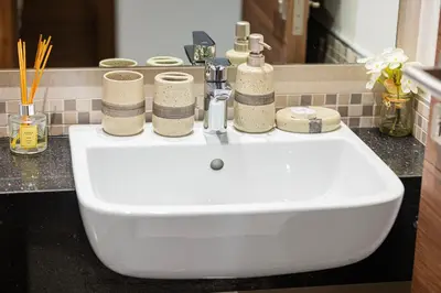a bathroom sink with towels on top of it at Lush 1BR Oasis in JVC With Gym & 5min to Circle Mall in Dubai