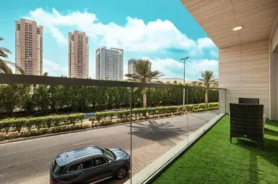a car parked on the side of a road at Lush 1BR Oasis in JVC With Gym & 5min to Circle Mall in Dubai