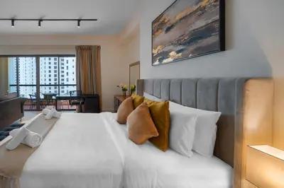a bedroom with a large white bed with a view at Rimal 3, JBR - Studio Apartment - Allsopp & Allsopp in Dubai