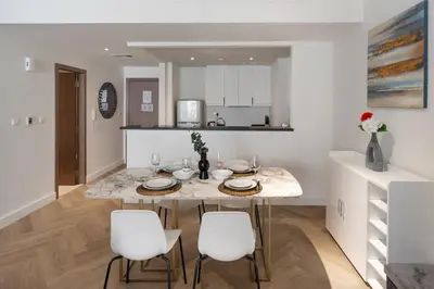 a kitchen and dining room with a table and chairs at Rimal 3, JBR - Studio Apartment - Allsopp & Allsopp in Dubai