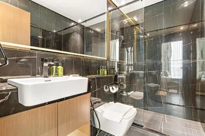 a bathroom with a sink and a toilet at Vayk - Modern 1BR Apartment in JVC in Dubai