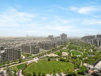 an aerial view of a city with buildings and a park at Dubai Hills 2BR Full Park View and Designer Style in Dubai