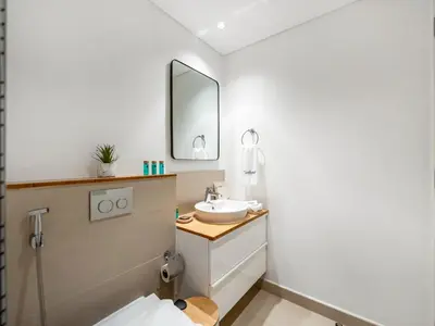 a bathroom with a sink and a mirror at Modern 1BR with Cinema, Pool and Gym Dubai Hills in Dubai