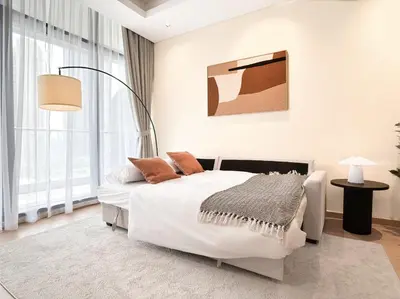 a white bedroom with a bed and a lamp at Luxe 1BR in RP Heights Downtown - 50mt to Dubai Mall, walk to Burj Khalifa and Fountain in Dubai