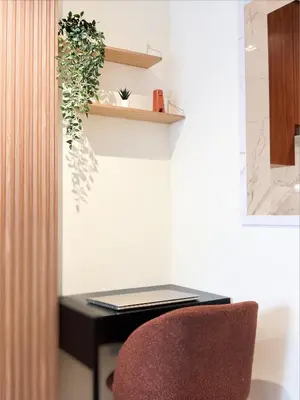 a laptop sitting on a desk with a chair at Luxe 1BR in RP Heights Downtown - 50mt to Dubai Mall, walk to Burj Khalifa and Fountain in Dubai