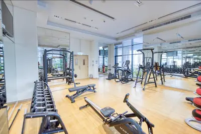 a gym with several treadmills and exercise bikes at Luxe 1BR in RP Heights Downtown - 50mt to Dubai Mall, walk to Burj Khalifa and Fountain in Dubai