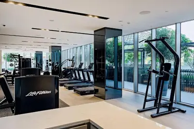 a gym with treadmills and ellipticals in a building at Bitcoin Moonrise 2BR - Grande Burj Views in Dubai