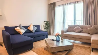 a living room with two couches and a coffee table at Silk Valley - Modern 2BR Near Park & Attractions in Dubai