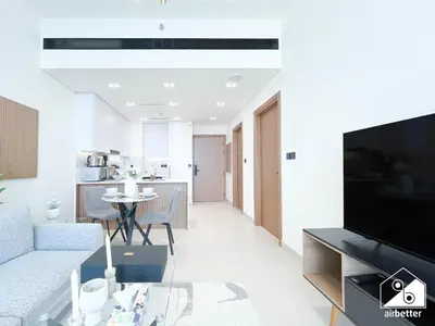 a living room with a couch and a table at Stylish 1BR Retreat in Binghatti Amber l Balcony in Dubai