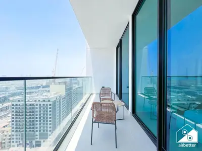 a balcony with a chair on the top of a building at Stylish 1BR Retreat in Binghatti Amber l Balcony in Dubai