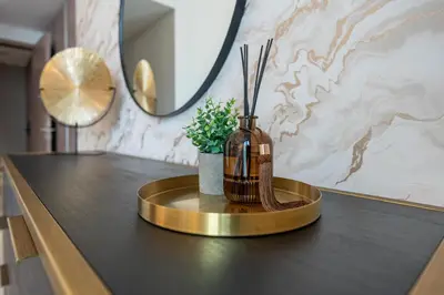 a bathroom counter with a vase with a plant on it at Unique & Stunning Marina Views LIV Residence 2BR in Dubai
