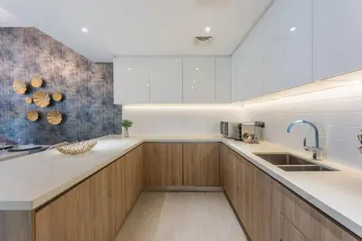 a kitchen with wooden cabinets and a sink at Unique & Stunning Marina Views LIV Residence 2BR in Dubai