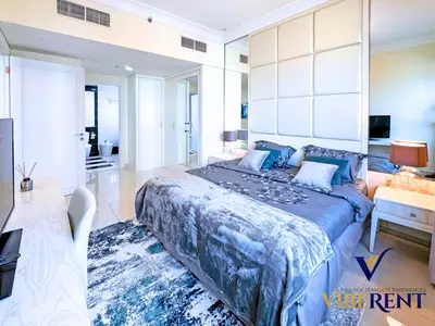 a bedroom with a large bed and a living room at Hotel Apartment next to Dubai Mall,Views & Vibes in Dubai