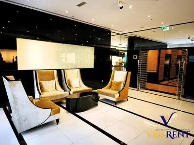 a lobby with a group of chairs and a screen at Hotel Apartment next to Dubai Mall,Views & Vibes in Dubai