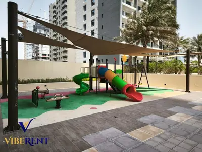 a playground with a slide and a swing set at Damac 1BHK, Terrance Pool, 20 Min to Downtown in Dubai