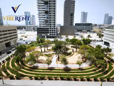 a park in the middle of a city with buildings at Damac 1BHK, Terrance Pool, 20 Min to Downtown in Dubai