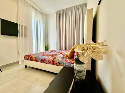 a bedroom with a bed and a window at Stunning studio with balcony close to metro in Dubai