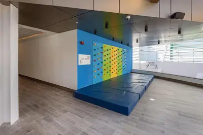 a room with a wall with a climbing wall at Vogue Arjan Opalz by Danube near Science Park, Studio Apartment with Balcony and Vibrant Community View, Access to all Amenities in Dubai