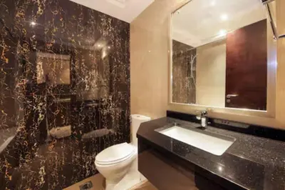 a bathroom with a toilet and a sink and a mirror at Dubai Downtown Canal View Studio 2306 in Dubai