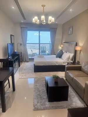 a bedroom with a bed and a couch and a table at Dubai Downtown Canal View Studio 2306 in Dubai