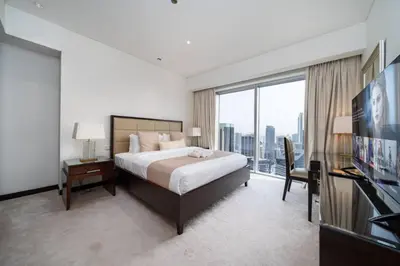 a hotel room with a bed and a large window at Waterfront Luxury 2 Bed in Marina Mall Hotel in Dubai