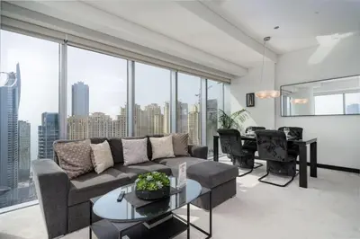 a living room with a couch and a table at Waterfront Luxury 2 Bed in Marina Mall Hotel in Dubai