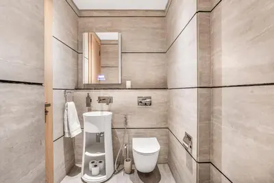 a bathroom with a toilet and a sink and a mirror at Brand New Luxury Studio in JVC in Dubai