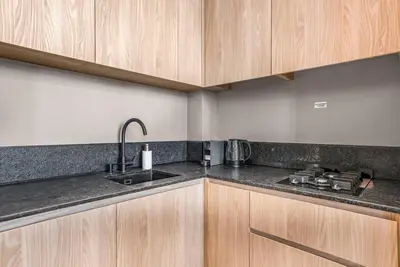 a kitchen with a sink and a counter top at Brand New Luxury Studio in JVC in Dubai