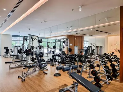 a gym with lots of treadmills and weights at Seraya at Dubai Creek South Residence in Dubai