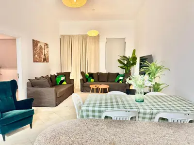 a living room with a table and a couch at Regent House 1 Motor City in Dubai