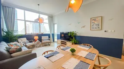 a living room with a table and a couch at Sea Breeze Luxury 2BR, Dubai Marina, Big Terrace, Near Beach, Pool access, by Stay Vista! for up to 6 Guests in Dubai