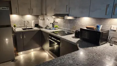a kitchen with stainless steel cabinets and a sink at Sea Breeze Luxury 2BR, Dubai Marina, Big Terrace, Near Beach, Pool access, by Stay Vista! for up to 6 Guests in Dubai