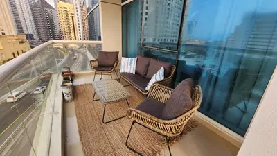 a balcony with chairs and tables on a building at Sea Breeze Luxury 2BR, Dubai Marina, Big Terrace, Near Beach, Pool access, by Stay Vista! for up to 6 Guests in Dubai