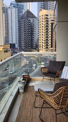 a balcony with chairs and a view of a city at Sea Breeze Luxury 2BR, Dubai Marina, Big Terrace, Near Beach, Pool access, by Stay Vista! for up to 6 Guests in Dubai